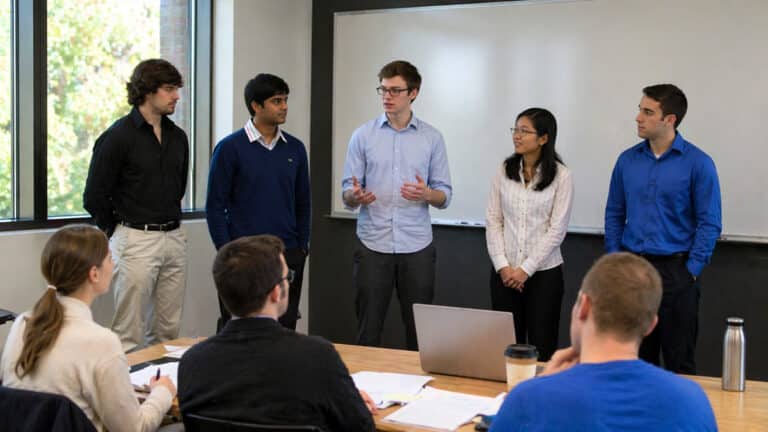 Monash University students presenting a group project to classmates in a Melbourne classroom setting