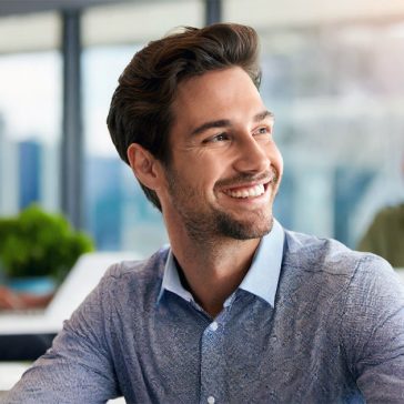 Male professional smiling at office desk