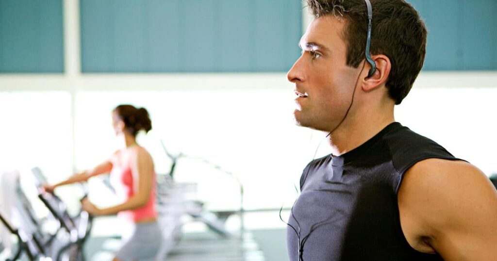 Man jogging on gym treadmill