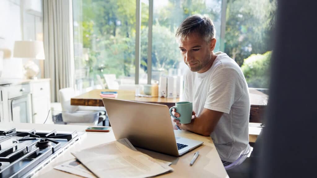 Older male employee working from home